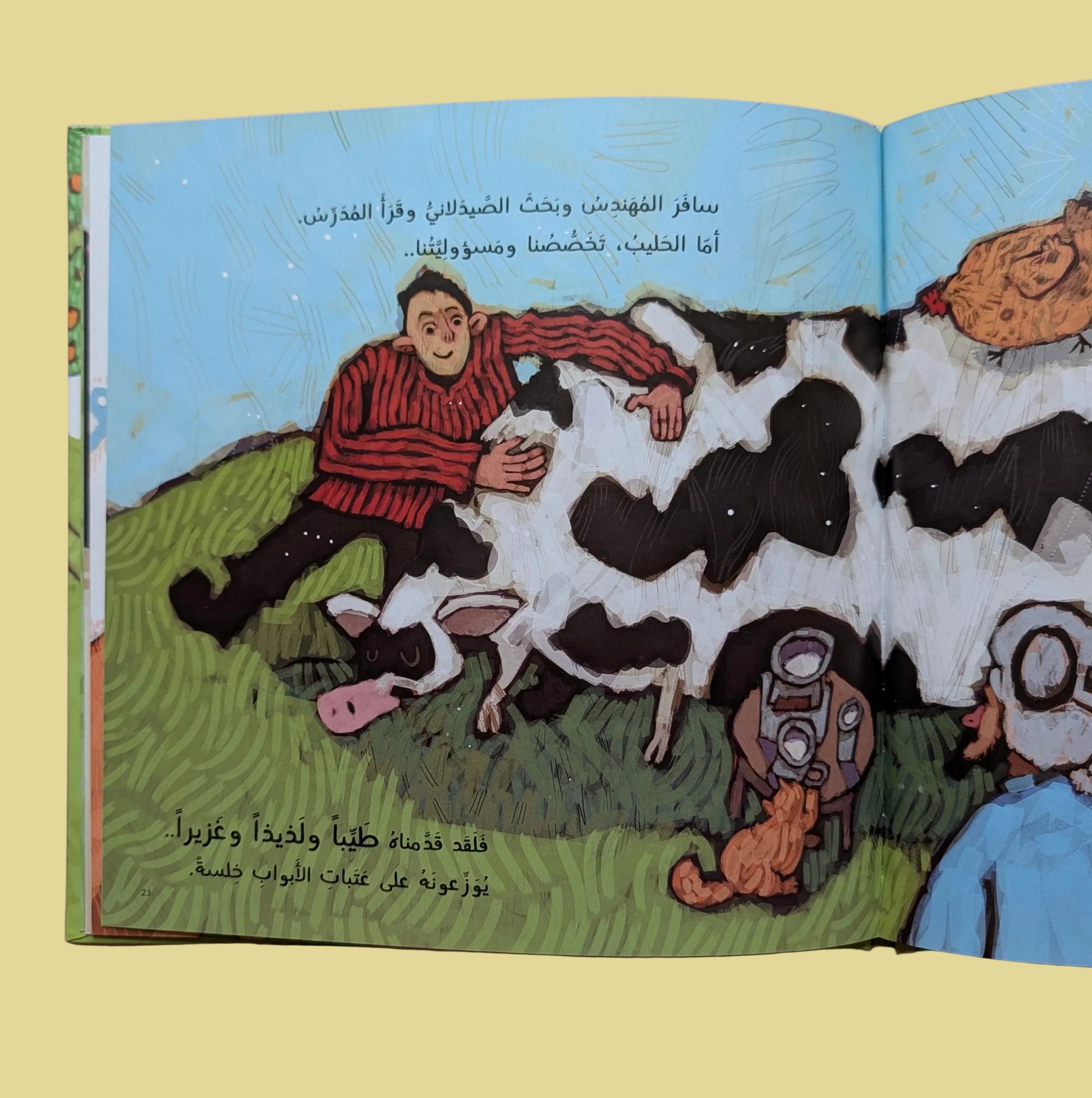 Open book with illustrations of a man and cow on a pink background